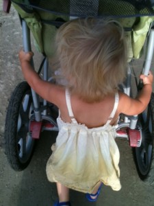 Happy with a purpose: pushing the stroller! 