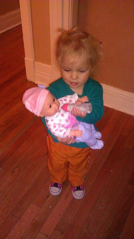 My granddaughter practices nurturing relationships with her first ever doll.